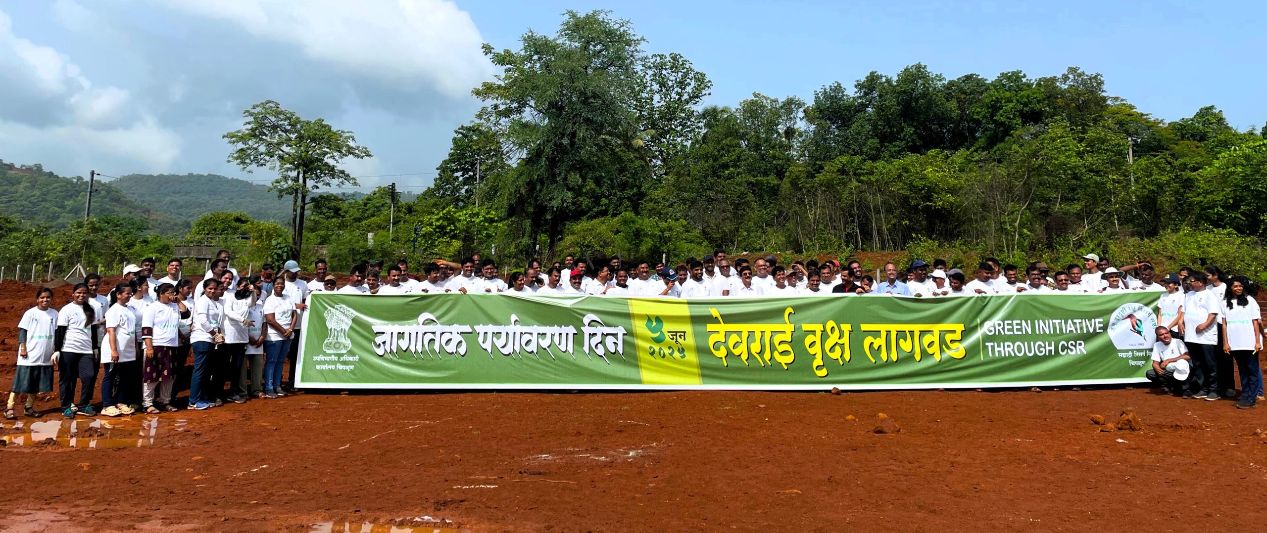 Participants of the Devrai plantation drive at Kalambaste, Chiplun with event banner on World Environment Day 2025